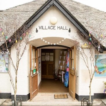 Exmoor Christmas market Fair is hosted by Porlock Village Hall - photo of the entrance to the village hall with christmas lights and decorations up