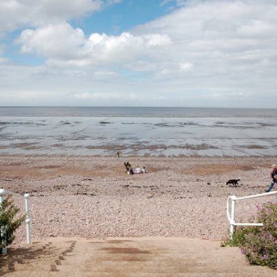 Access by steps down onto the beach