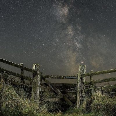 Wooden gate in fence with Exmoor starry skies behind with spooky Halloween vibes