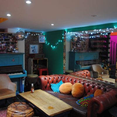 Go this Halloween to Charlie Fridays - here you see the downstairs area with colourful decor, fairy lights and comfortable furniture