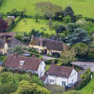 Birds eye view over Exmoor village of Bossington with greenery surrounding