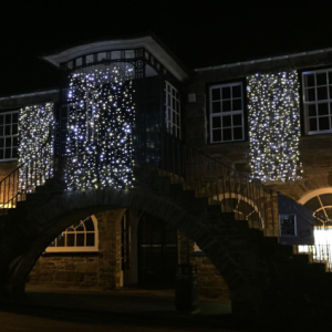 Dulverton town hall lit up with curtains of fairy lights