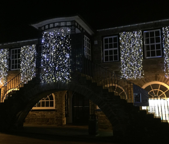 Dulverton town hall lit up with curtains of fairy lights
