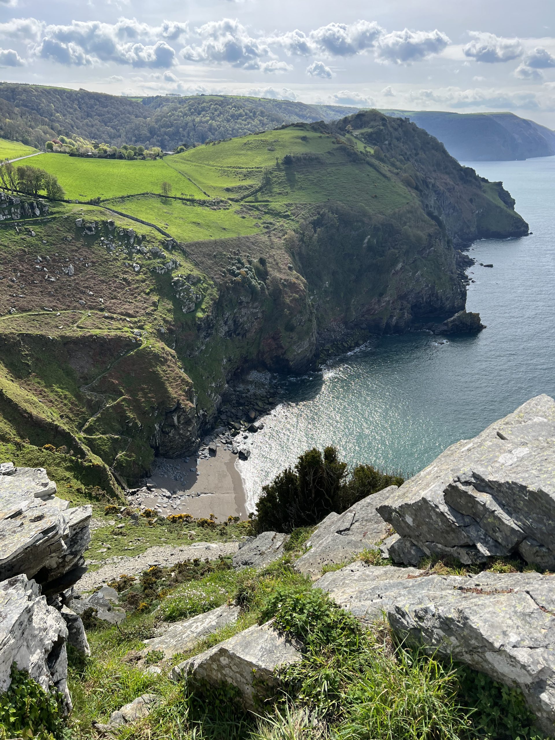 A stunning photo of Wringcliff Bay, Exmoor from up on the cliffs with the sea and the beach below