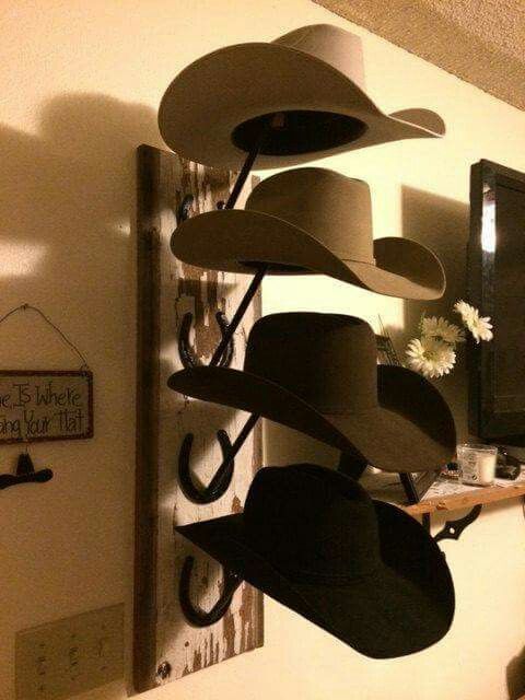 Cowboy hats on a hat stand on a wall