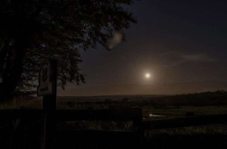 Full moon shining brightly in the Exmoor night sky