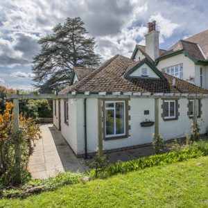 The Bramleys, a charming holiday cottage in Old Cleeve near Cleeve Abbey with sunshine filtering through clouds in the surrounding countryside